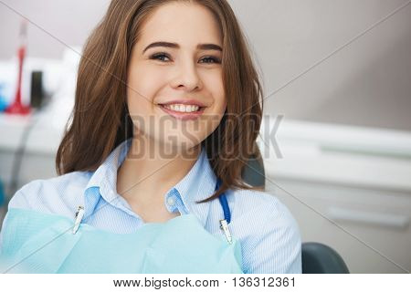 Portrait Of Happy Patient In Dental Chair.