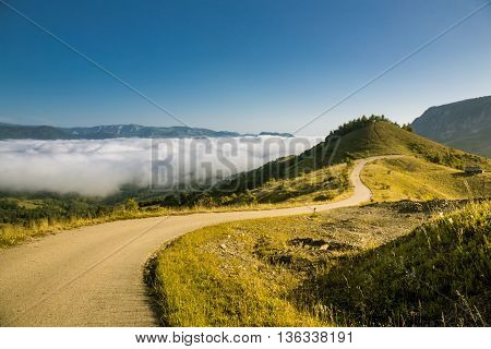 Colorful morning mist up the hills in the Romanian Apuseni Mountains near Salciua