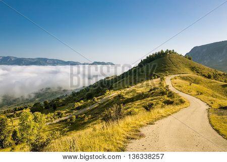 Colorful morning mist up the hills in the Romanian Apuseni Mountains near Salciua