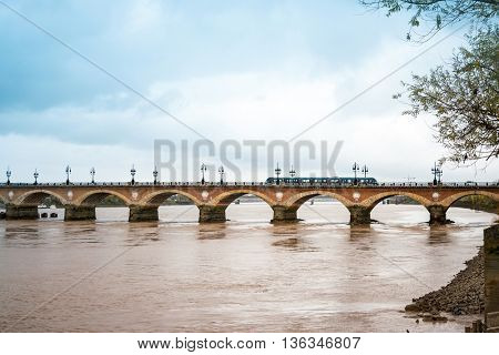 Old stony bridge in Bordeaux, France Europe