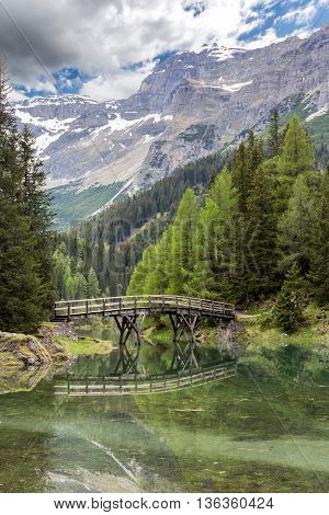 Wooden bridge over lake Obernberg in the Austrian Alps