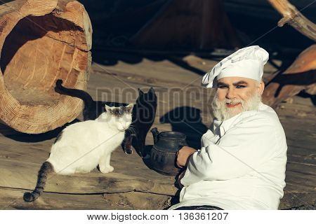 Bearded Cook With Kettle And Cats