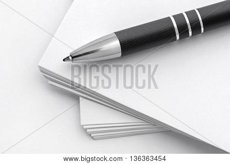 Selective focus image of pen on stack of paper