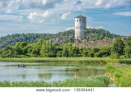 STEGEBORG, SWEDEN - JUNE 25: The bay of Slatbaken and Stegeborg Castle on June 25,2016 in Stegeborg during midsummer in Sweden. Stegeborg is a historic medieval royal castle.