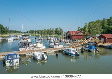 STEGEBORG, SWEDEN - JUNE 25: Leisure boat marina in the bay of Slatbaken  in Stegeborg during midsummer in Sweden. Midsummer is one of the major holidays in Sweden.