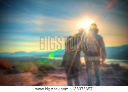 Abstract Blurred and soft photo of the lover standing on the hilltop during sunrise.