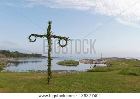 Tiny maypole small harbor and the sea in the background. No people