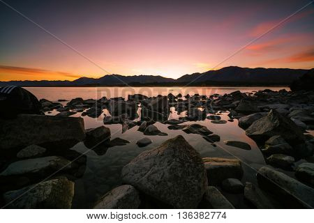 Scenic sunrise at Lake Tekapo in the glacier valley in Canterbury, New Zealand during autumn.