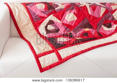 Patchwork quilt. Part of patchwork quilt as background. A blanket in style patchwork. Color blanket. Handmade. Rose print.