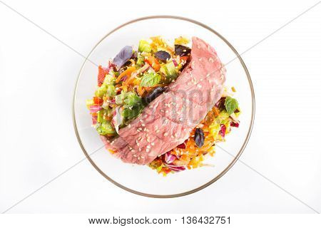 Roastbeef salad in a bowl on a white background
