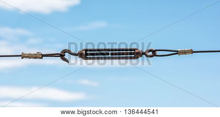 Metallic rope with hook. Industrial scene. Fasteners theme. Taut rope.