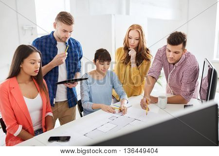 business, startup, education and people concept - creative architect team or students with blueprint working at office