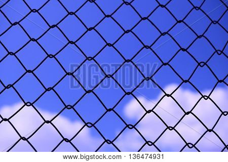 View blue sky with cloud background behind rusty grate - abstract background