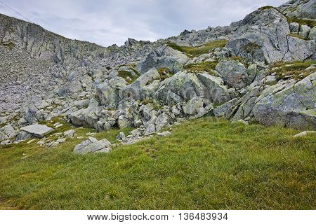 Rocks and green grass under Momin Dvor peak, Pirin mountain, Bulgaria