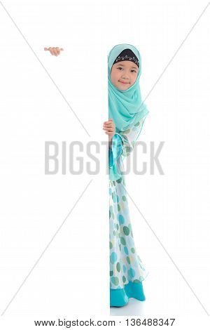 Portrait of asian muslim girl with an empty banner on white background isolated