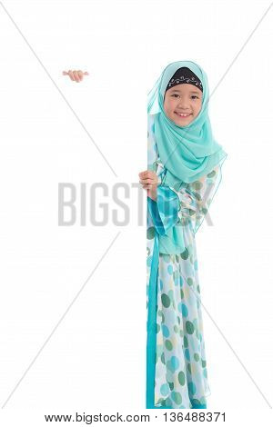 Portrait of asian muslim girl with an empty banner on white background isolated