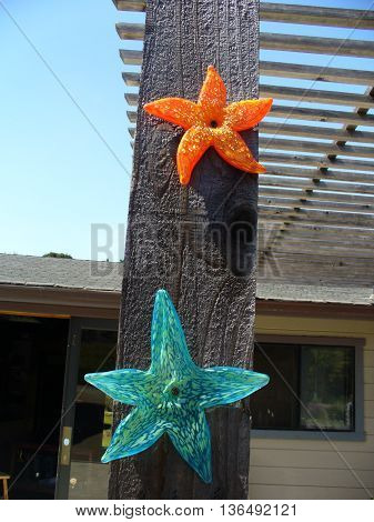 Blown glass star fish hang on a pillar