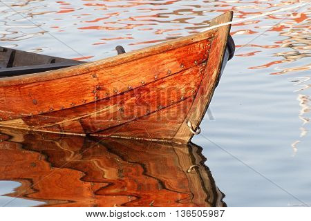 Closeup of wooden rowboat in warm evening light