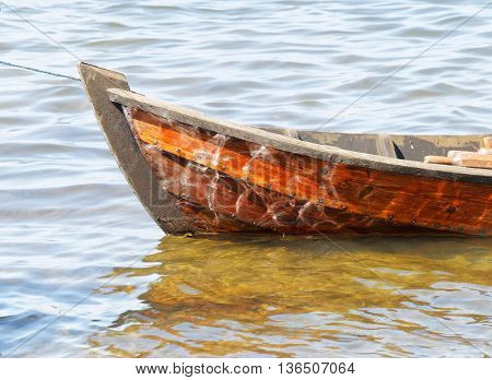 Closeup of wooden rowboat in warm evening light