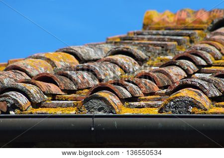 traditional roof tile with tiles and cement and plaster of historic urban or rural building