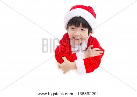 Little asian boy in Santa Claus uniform with an empty banner isolated on white