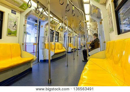 Bangkok Thailand - June 18 2016: Overview of yellow seats in electric train Public Transportation in Bangkok. Sky train / BTS elevated rails