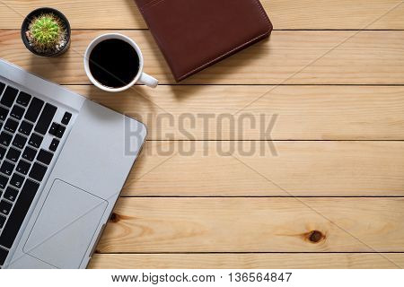 Top view office stuff with labtop cup of coffee and leather notebook with workspace.Flat lay image