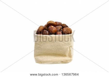Many chestnuts in small sack isolated on white background