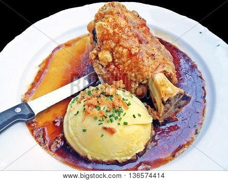 Crispy German pork knuckle with big scoop of mash potato