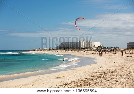 CORRALEJO, FUERTEVENTURA, SPAIN - SPETEMBER 15, 2015: Tourists rest on Corralejo Beach on Fuerteventura Canary Islands