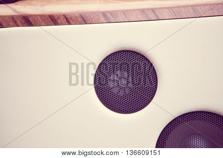 Close up image of a car's stereo speaker.