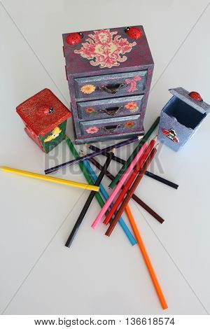 A handmade mini chest of three drawers decoupaged with floral vintage paper handmade objects decorated using different techniques of decoupage