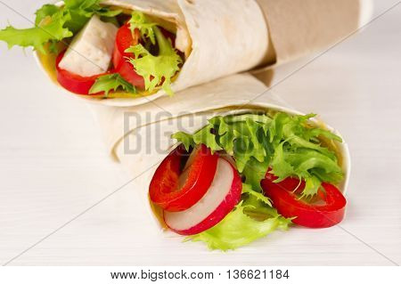 Vegan shawarma wrap roll with vegetabes and cheese.
