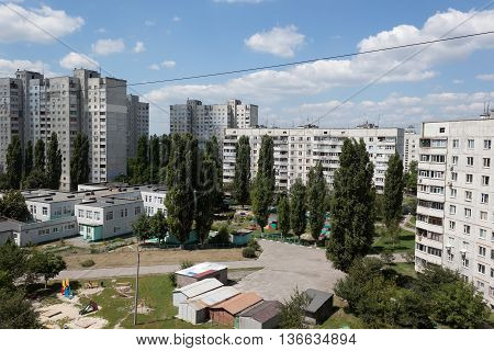 The courtyard between the Kharkiv Soviet-built apartment blocks party-cloudy summer day. Ukraine June 2016