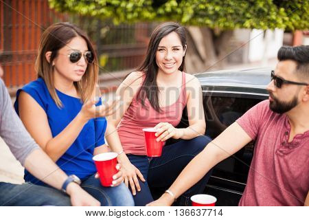Beautiful Hispanic woman hanging out with family and friends and tailgating on a sunday game