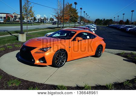 NAPERVILLE, ILLINOIS / UNITED STATES - NOVEMBER 3, 2015: A bright orange RC F luxury sport coupe is on display on the lot of Lexus of Naperville.