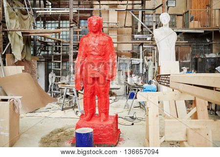 RUSSIA, MOSCOW - MAY 28, 2015: Clay sculpture covered by red silicon rubber in the workshop of sculptor Salavat Shcherbakov. It is one of the stages of manufacture of a bronze sculpture.