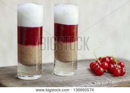 Milkshake With A Currant And Raspberry. Cocktail Layers On The Wooden Boards