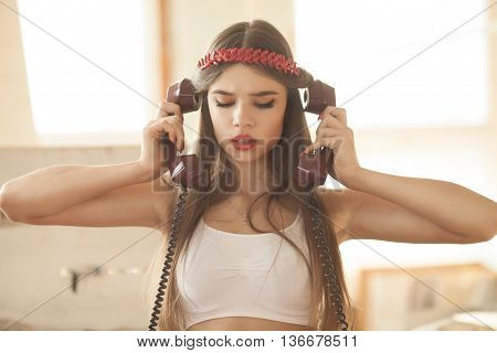 pretty woman talking on old telephone. Fashion model. Red lips. Sunny color.