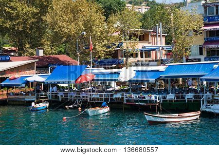 Anadolu Kavagi Turkey - Aug 28 2013: Waterfront restaurants and cafes of a small fishing village Anadolu Kavagi is popular among tourist and locals for Yoros Castle tours
