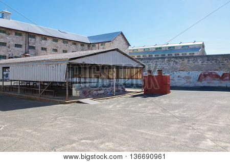 FREMANTLE,WA,AUSTRALIA-JUNE 1,2016:  Fremantle Prison yard with shelter under a clear blue sky in Fremantle, Western Australia.