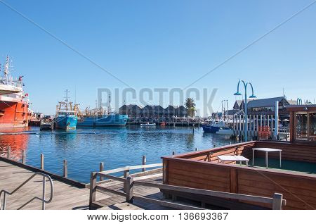 FREMANTLE,WA,AUSTRALIA-JUNE 1,2016:Fremantle Fishing Boat Harbour and water front restaurants under a clear blue sky in Fremantle, Western Australia.