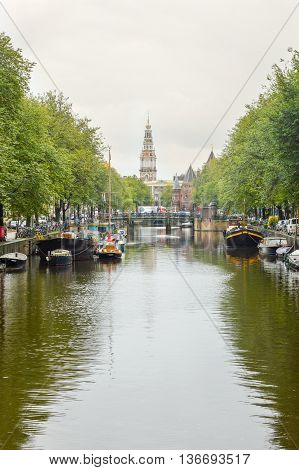Amsterdam - September 17, 2015: View At The Famous Clock Tower Of The Zuiderkerk Thro Amsterdam Cana