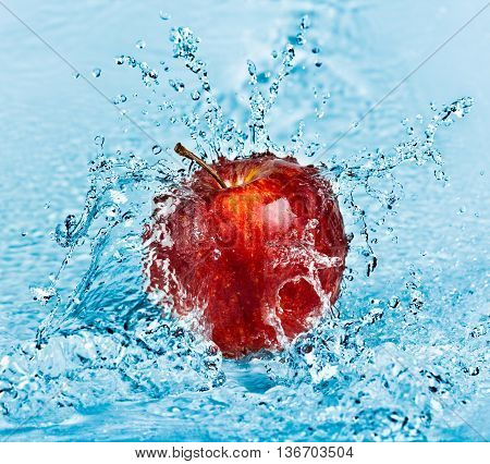 image of fresh water splash on red apple