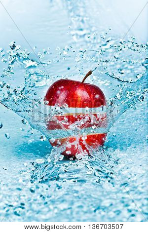 image of fresh water splash on red apple