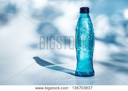 Image of bottle of water on blue background