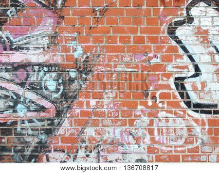 Brick wall background with graffitis and copy space