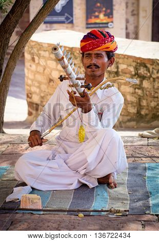 Indian Musician In Traditional Dress Playing Musical Instruments
