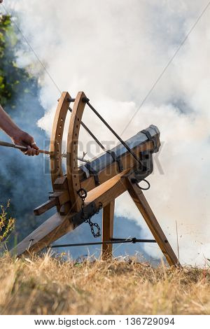Man shoots with gun - white smoke in the background