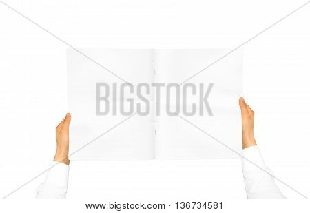 Hand in white shirt sleeve holding blank journal in the hand. Empty magazine presentation. Pamphlet hand man. Man show pages. Sheet template. Booklet in hands. Book design. Catalog sheet display.